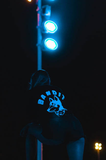 Bandit Logo Tee black back woman standing in front of lightpost